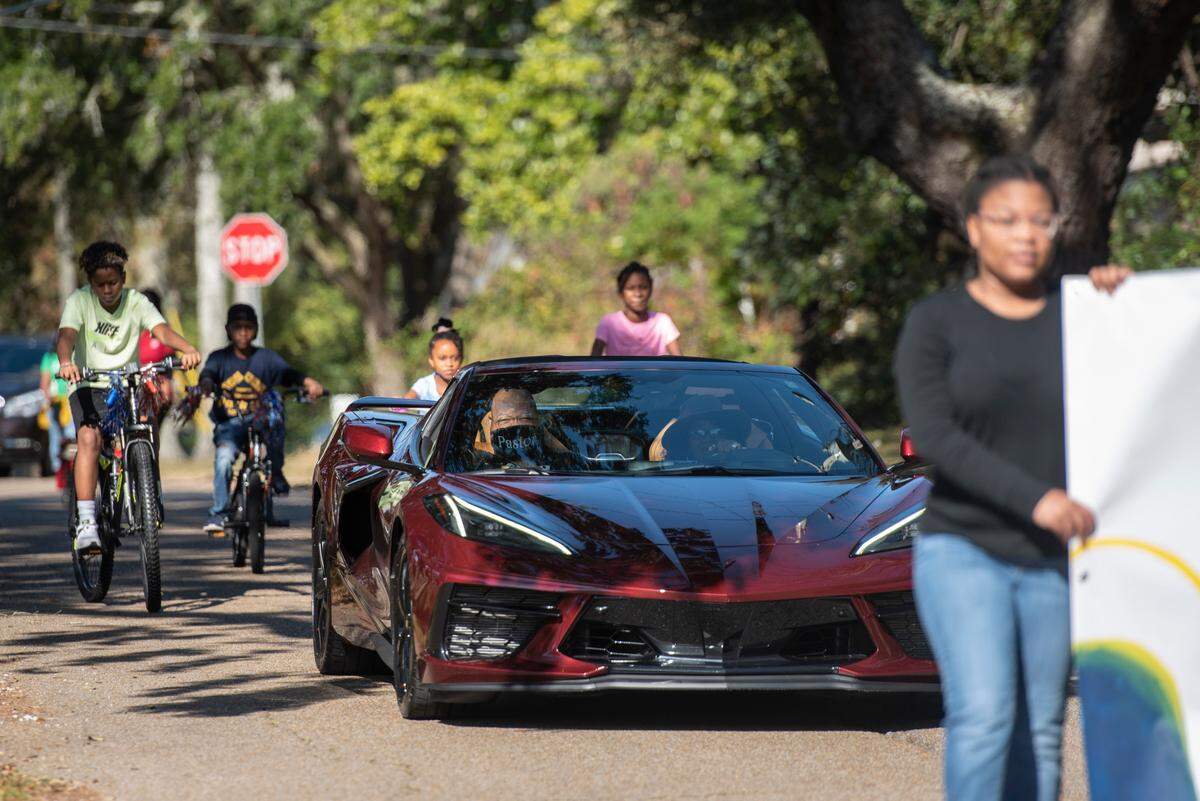 A car driving Pastor Seymour Venson Adolph, Jr. leads a parade to Handsboro Baptist Church in celebration of Adolph’s retirement in Gulfport on Saturday, Dec. 4, 2021.