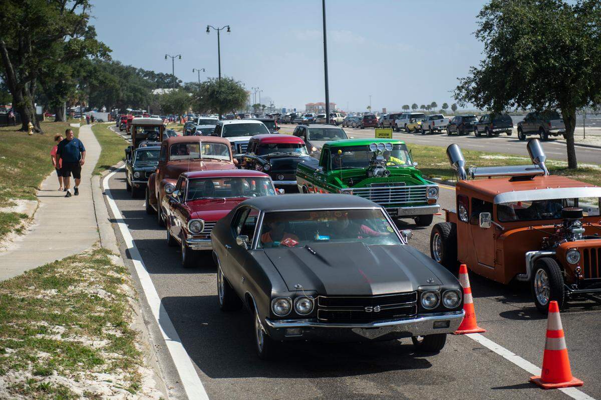 A lineup of classic cars waits to turn into Cruise Central at Centennial Plaza.