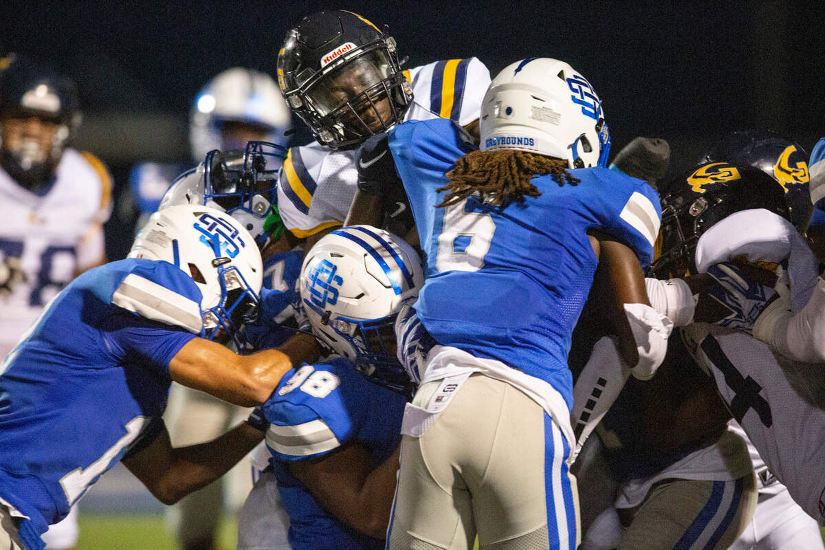 The Ocean Springs’ defense pushes back and tackles Gautier’s ball carrier during a Jamboree game at Ocean Springs on Friday, Aug. 19, 2022.