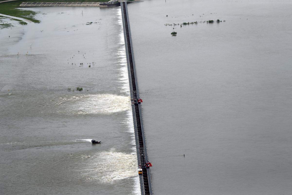 In this Friday, May 10, 2019, file photo, workers open bays of the Bonnet Carré Spillway to move rising water from the Mississippi River to Lake Pontchartrain, upriver from New Orleans, in Norco, La. Bonnet Carré openings in 2019, which lasted a record 123 days, decimated Mississippi Sound oyster beds and killed dolphins.