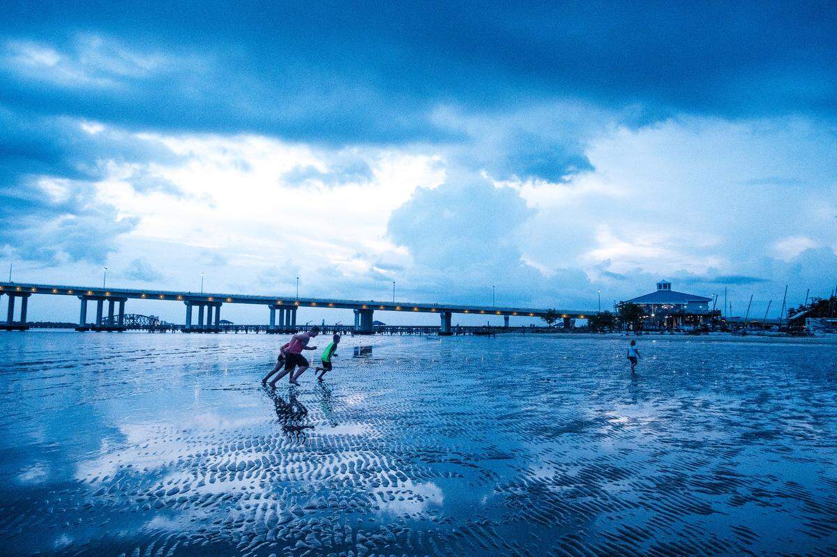 A family races back to the sand prior to the fireworks show on Front Beach in Ocean Springs in 2020. Besides the fireworks, July 4 will be celebrated with music, good food and family fun.