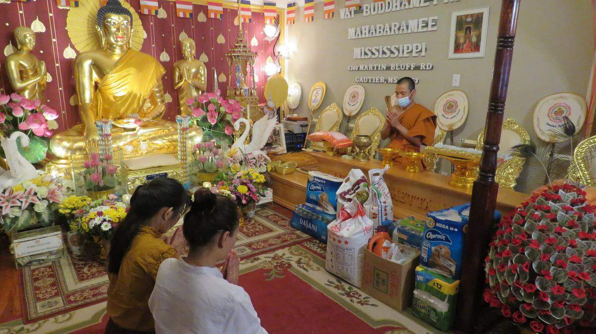 Pisit Opnititanit, the head monk at Wat Budhametta Mahabaramee in Gautier, prays with worshippers on April 11, 2021 at the temple’s Songkran, or Thai New Year, festival.