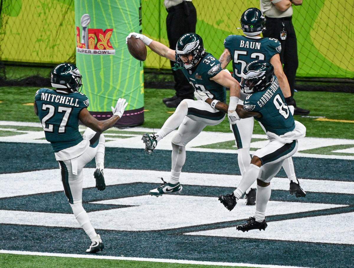 Philadelphia Eagles cornerback Cooper DeJean (33) celebrates with teammates after intercepting a pass thrown by Kansas City Chiefs quarterback Patrick Mahomes in the second quarter and running it in for a touchdown during Super Bowl LIX on Sunday, Feb. 9, 2025, in New Orleans.