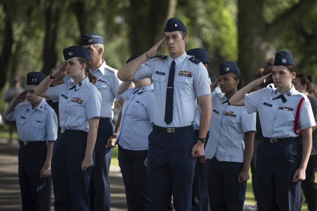Civil Air Patrol members salute the flag during a Memorial Day ceremony at Biloxi National Cemetery in Biloxi on Monday, May 26, 2025.