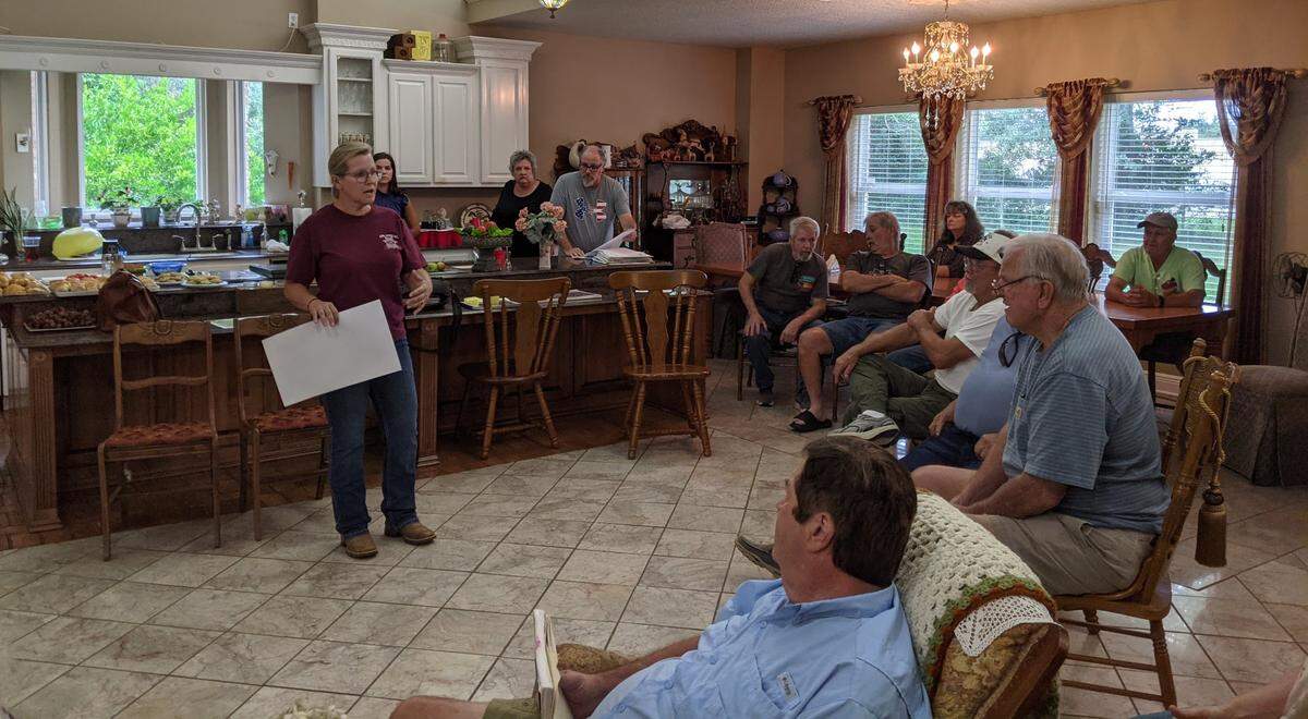 Harrison County constable Angel Kibler-Middleton, previously on the Board of Supervisors, is pictured in this file photo at her parent’s home on a 10-acre farm. She is speaking with neighbors about a subdivision they successfully opposed in 2022 at a nearby location.