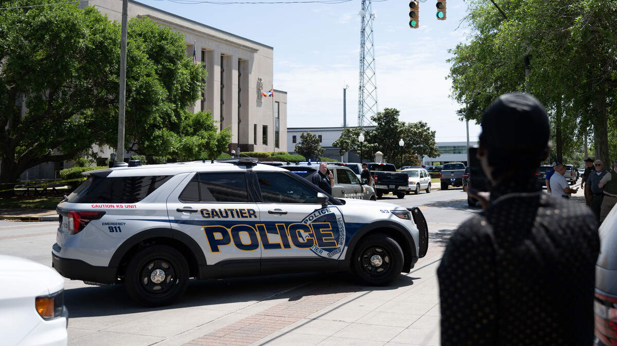 Police cars and pedestrians gather outside the Jackson County Courthouse in Pascagoula after a shooting on Thursday, April 16, 2026.