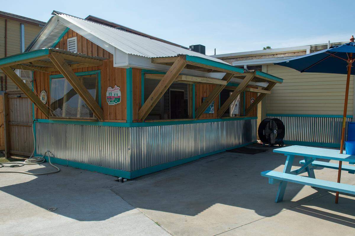 The outdoor kitchen at the new Back Yard beer garden eventually will let customers purchase meats at the butcher shop and seafood market and then have them cooked outdoors.