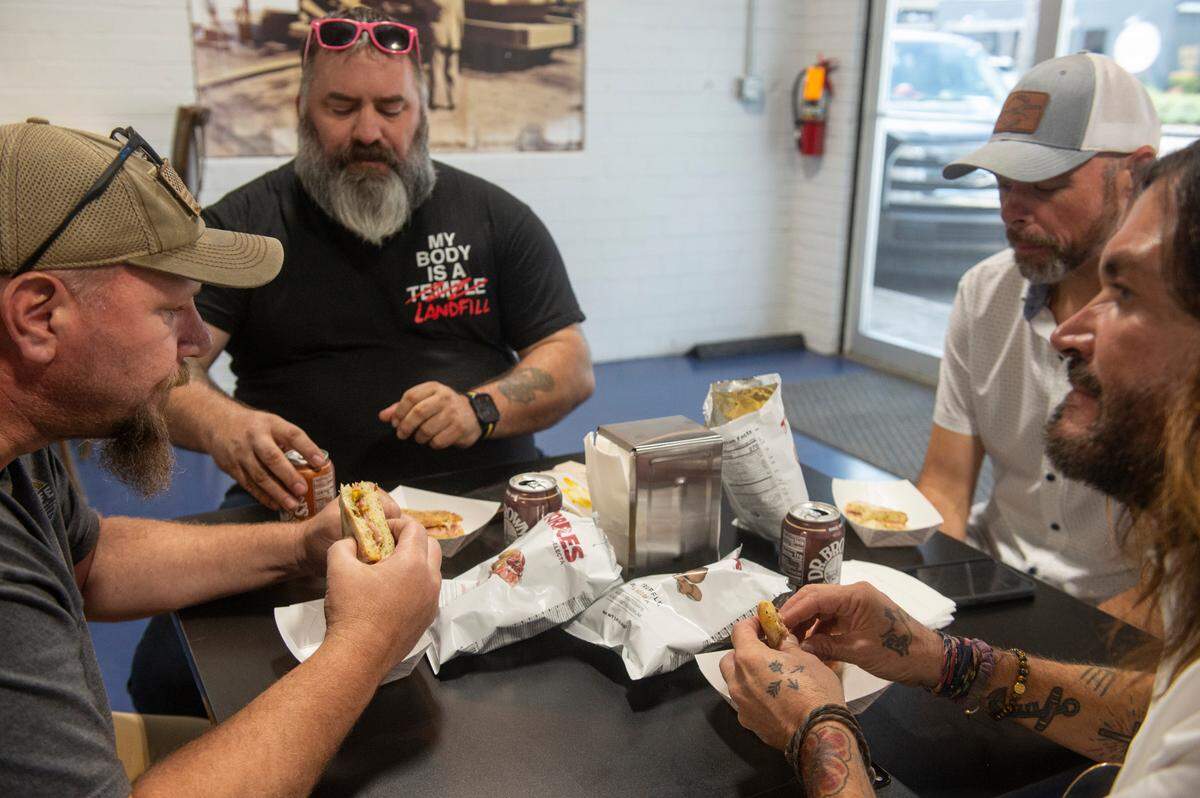 A group participates in an early tasting event at Tavi’s Salumeria in Gulfport.