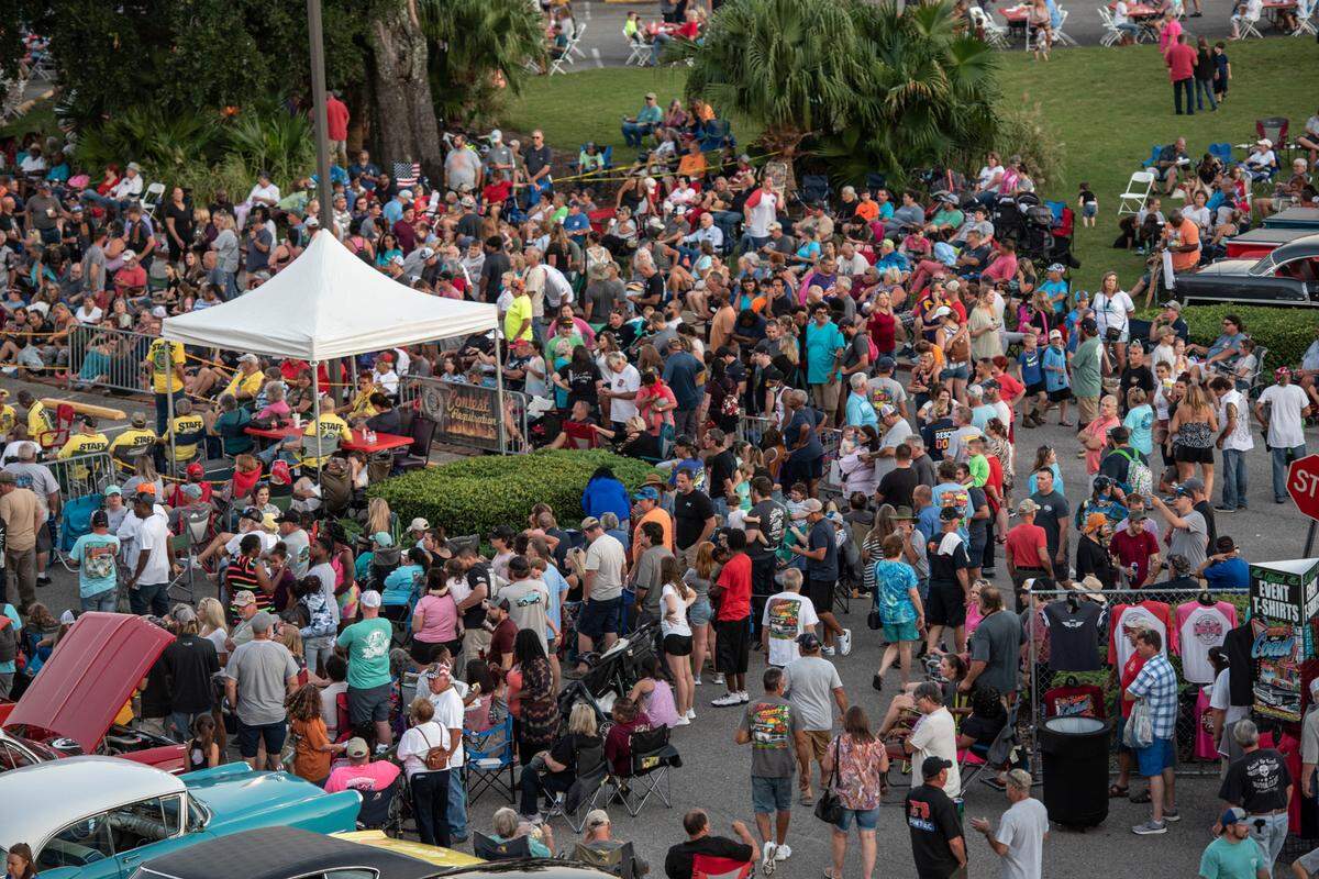 Crowds gather to watch the flame throwing competition, where drivers compete to see which car can produce the biggest flames, at Island View Casino in Gulfport during Cruisin’ The Coast on Tuesday, Oct. 5, 2021.