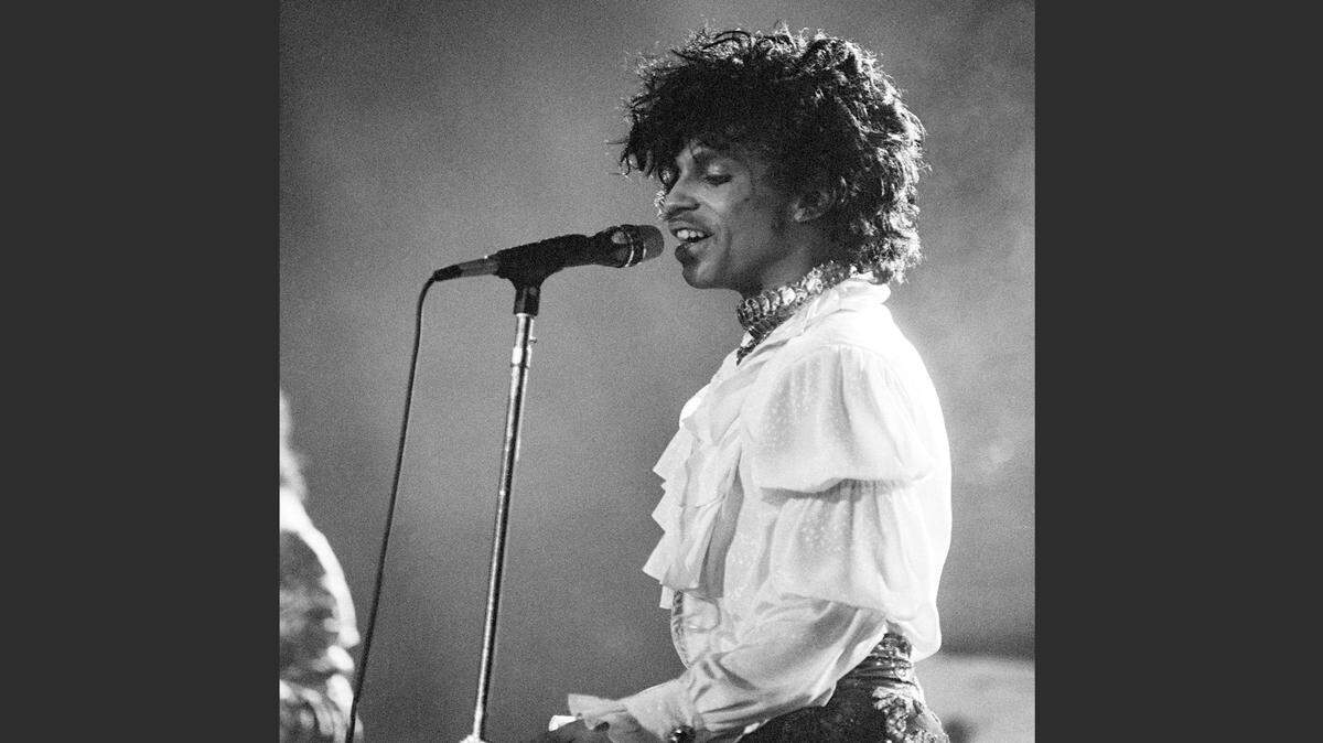 FILE - In this April 7, 1985 file photo, Prince performs at the Orange Bowl during his Purple Rain tour in Miami. Prince, widely acclaimed as one of the most inventive and influential musicians of his era with hits including "Little Red Corvette," ''Let's Go Crazy" and "When Doves Cry," was found dead at his home on Thursday, April 21, 2016, in suburban Minneapolis, according to his publicist. He was 57. (AP Photo/Phil Sandlin, File)