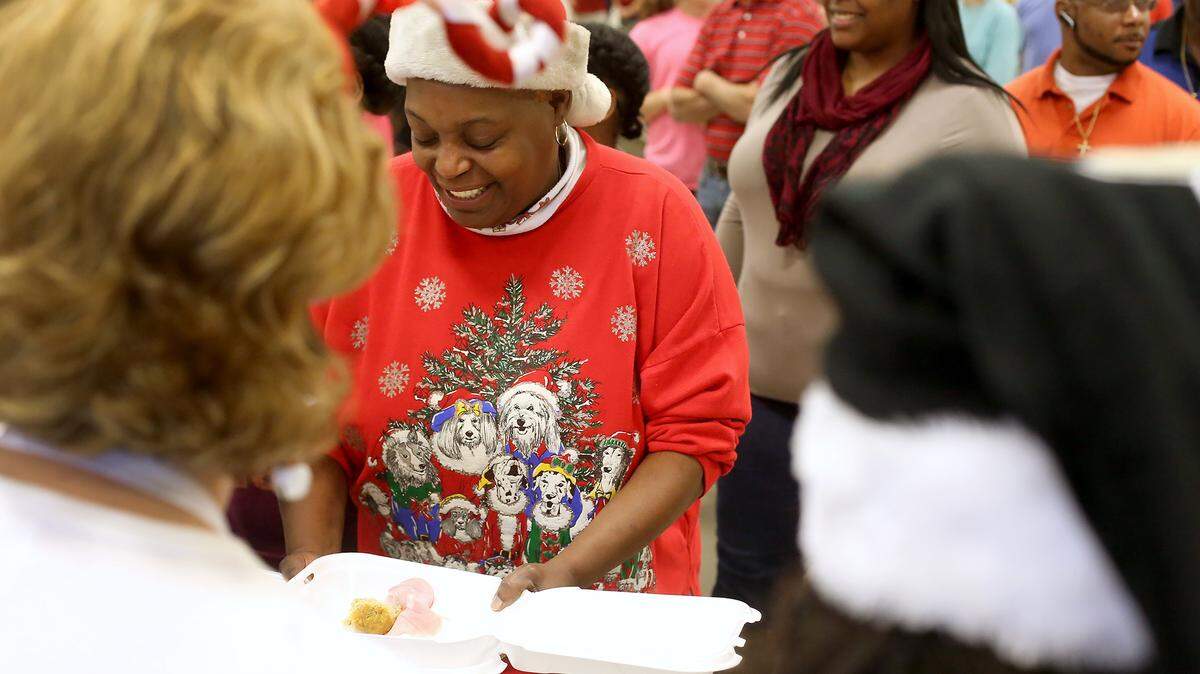 AMANDA McCOY/SUN HERALD 
 Bertha Bradley helps prepare holiday meals during the 26th annual Gulf Coast Public Safety Feed the Needy Program on Friday, December 25, 2015. Around 250 volunteers helped package the food, which was then delivered to those in need.