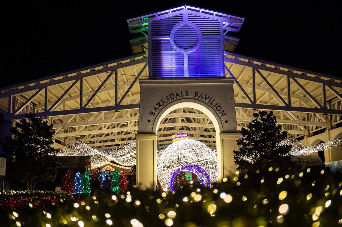 The Barksdale Pavilion, which is where visitors can visit with Santa, is illuminated with a giant ornament made of Christmas lights during the Harbor Lights Winter Festival at Jones Park in Gulfport on Thursday, Dec. 2, 2021.