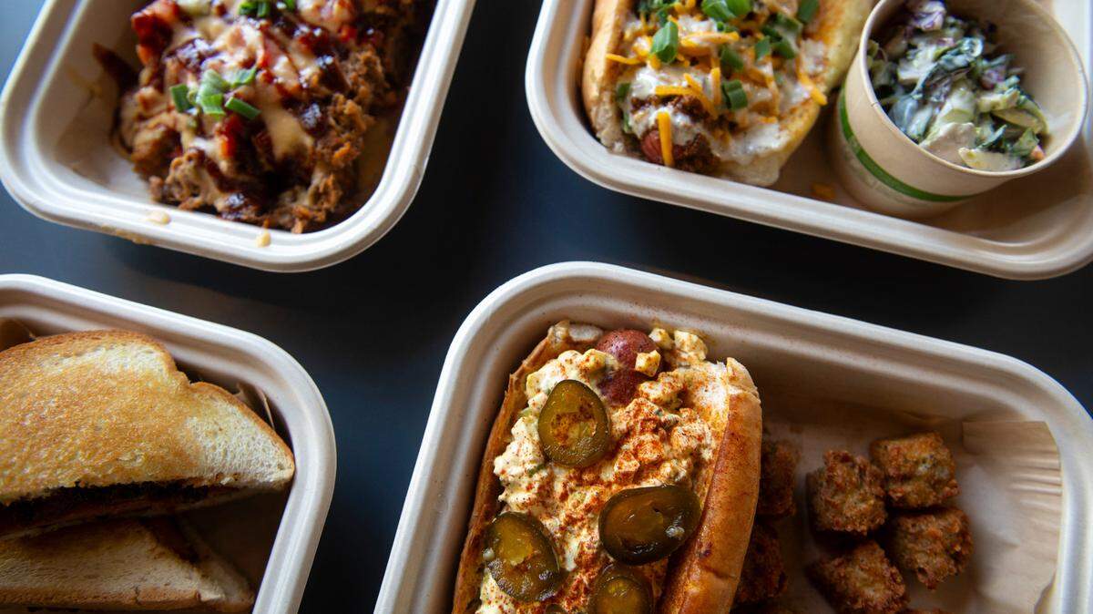 The deviled egg dawg, bottom right, the campfire dawg, top right, the loaded totchos, top left, and the fried bologna sandwich, bottom left, at The Garage at Cash Alley in Ocean Springs on Friday, Dec. 13, 2024.