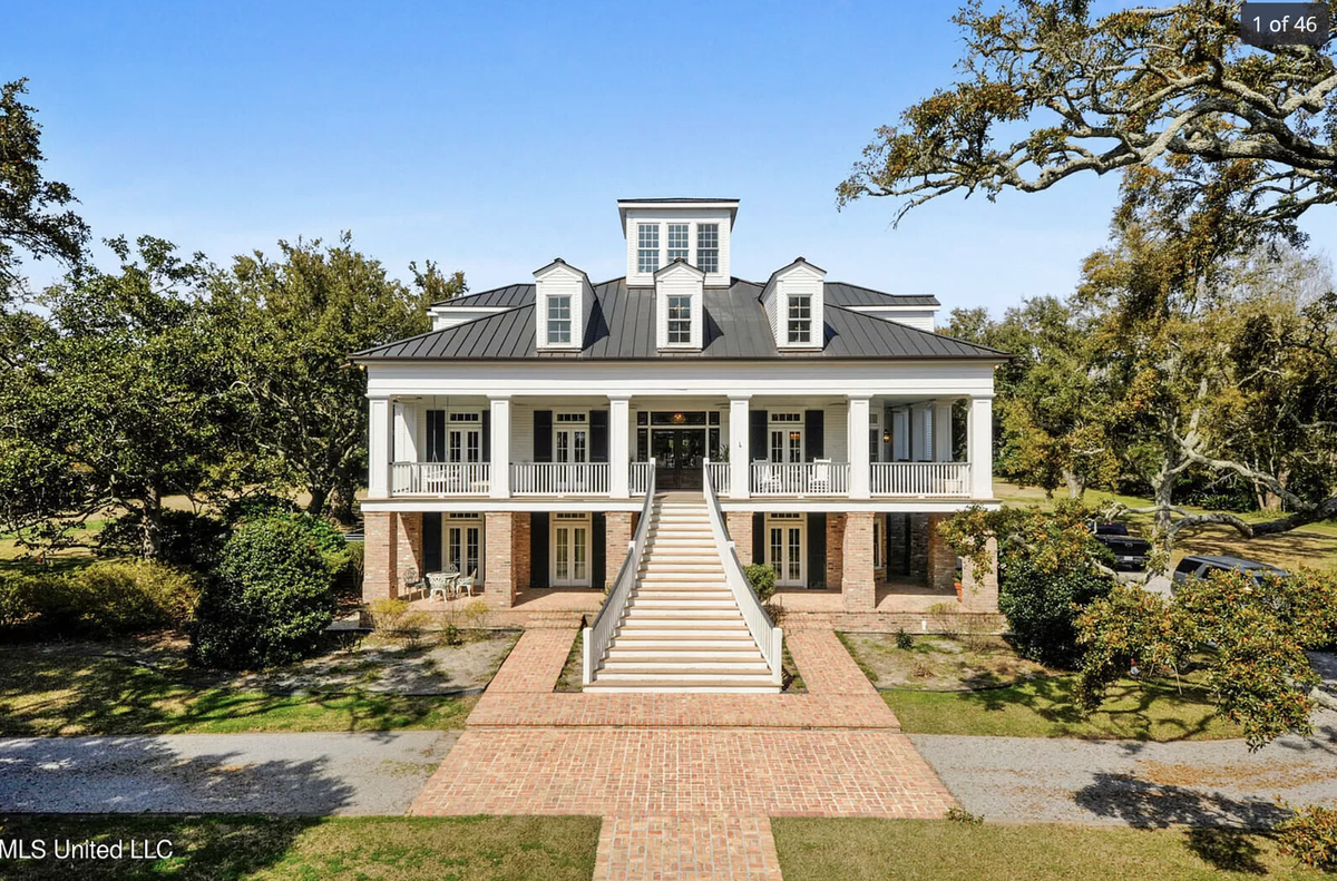 A home for sale for $4.9 million on E. Beach Boulevard in Pass Christian has a tree-lined brick walkway that leads from the home to the beach.