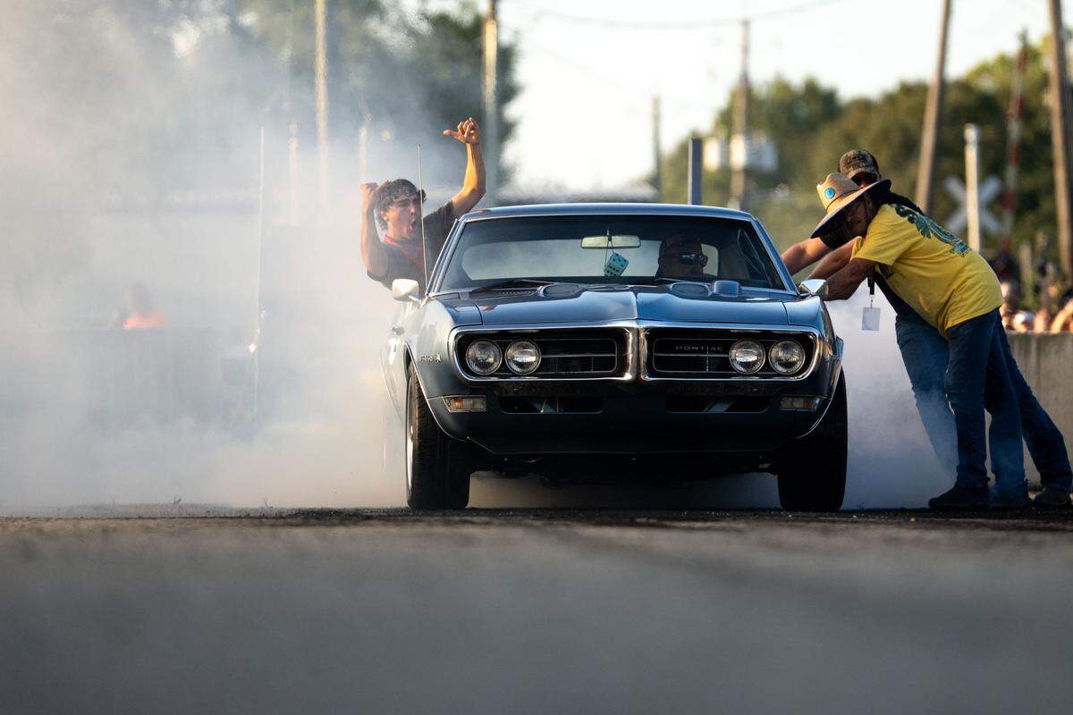 A passenger cheers as his car burns out during Burn ‘Em Up In The Pass on Thursday, Oct. 9, 2025.