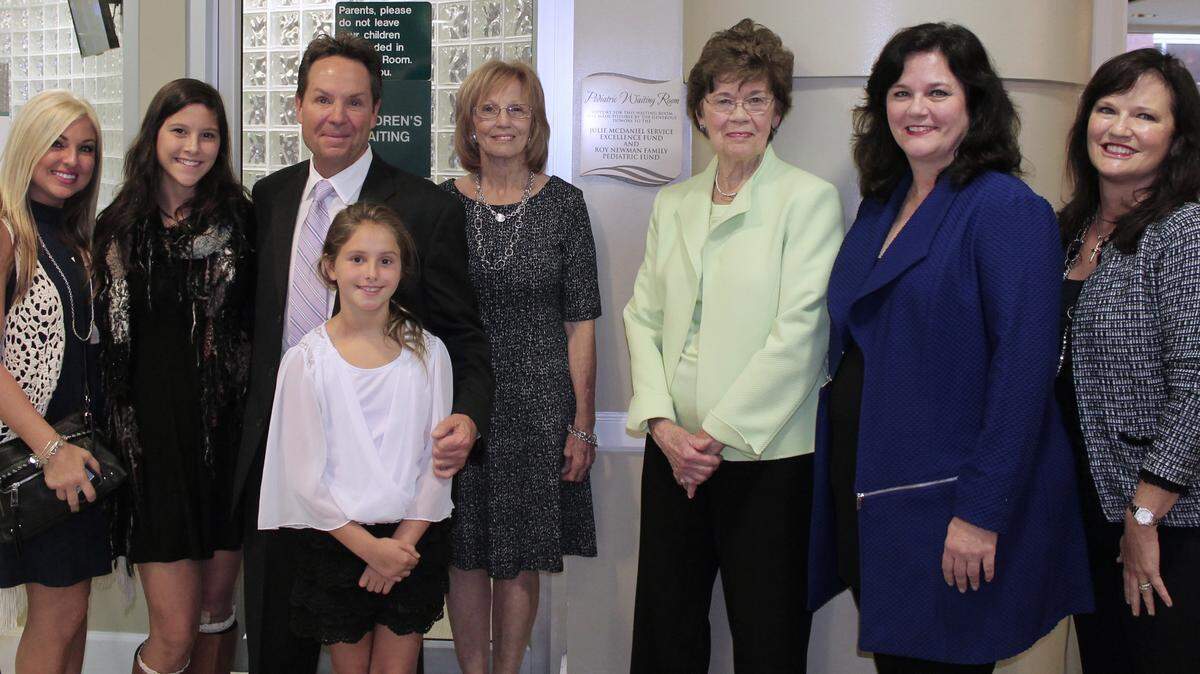 From left, Markelle McDaniel, Brooke Mitchell, Mark McDaniel, Jada McDaniel, Jackie Woodcock, Elizabeth Newman, Cindy Newman, and Roianne Newman Gutierrez stand in the newly renovated Emergency Department Pediatric Waiting Room at Memorial Hospital.