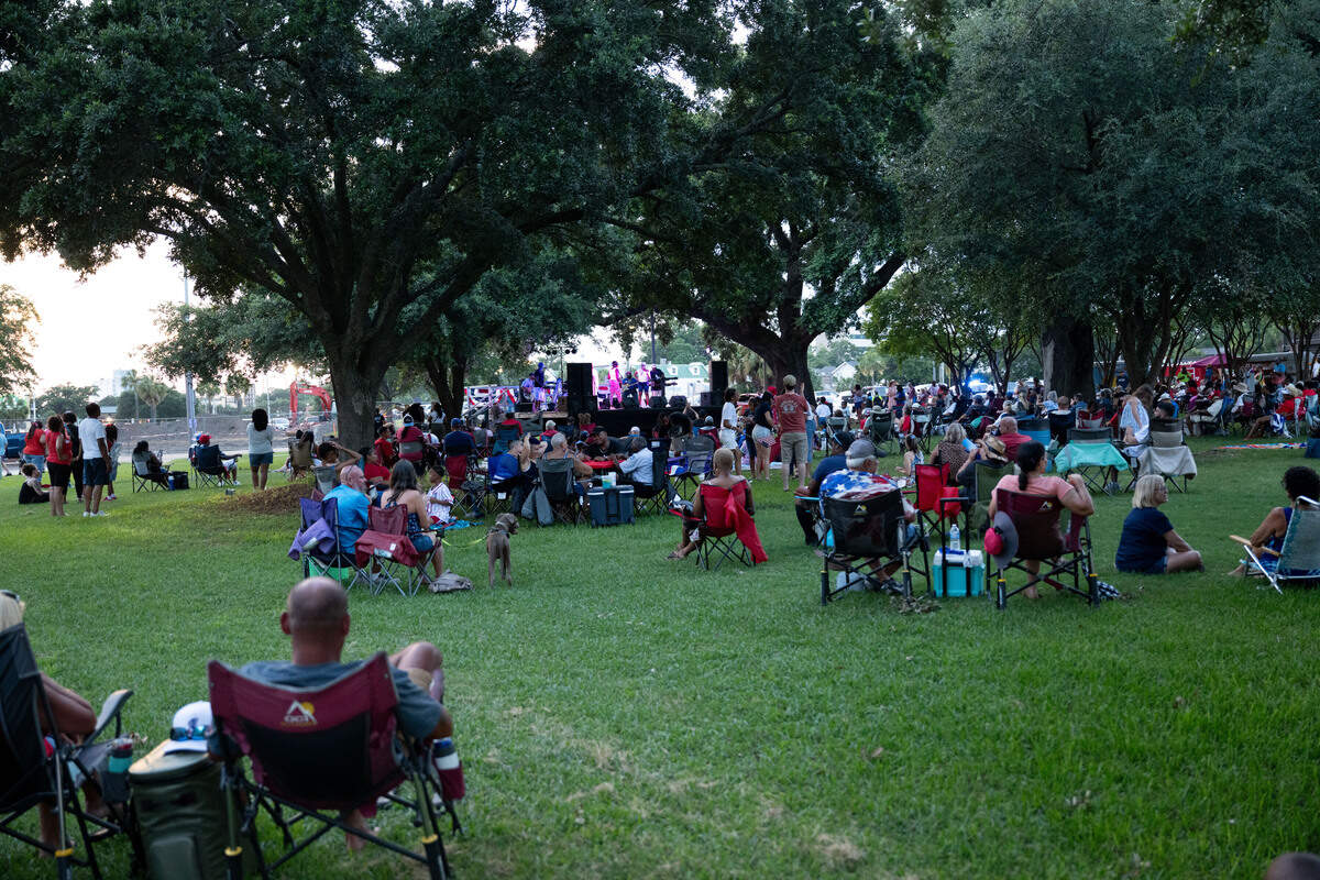 People gather to listen to live music by Unfazed Show & Dance during the Fourth of July show at the Biloxi Town Green on Saturday, July 4, 2026.