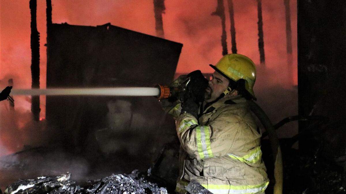 A firefighter works to put out a blaze at a Kiln home, where the body of a 72-year-old man was found on the steps of his trailer on Friday, Nov. 16, 2018. The fire claimed his life and destroyed his home on Standard Dedeaux Road.