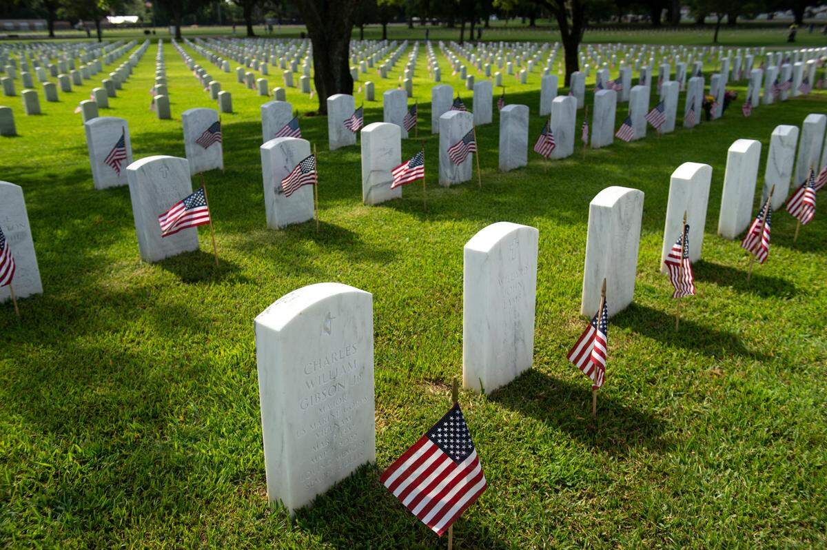Thousands of tiny American flags decorate the graves of American service members at Biloxi National Cemetery in Biloxi ahead of Memorial Day on Saturday, May 25, 2024.