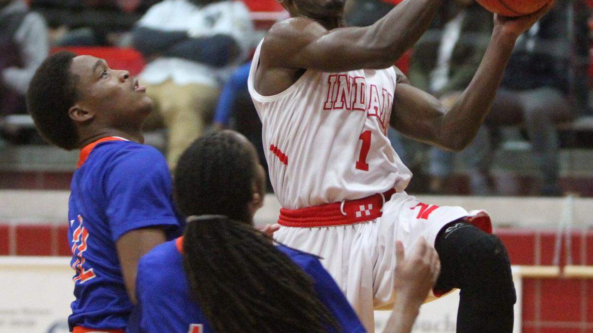 JOHN FITZHUGH/SUN HERALD 
 Biloxi's Jordan Lewis drives to the basket against Gulfport's Alton Conerly and Tyrell McArthur(11) during the first half of their game at Biloxi on Friday Jan. 22, 2015.