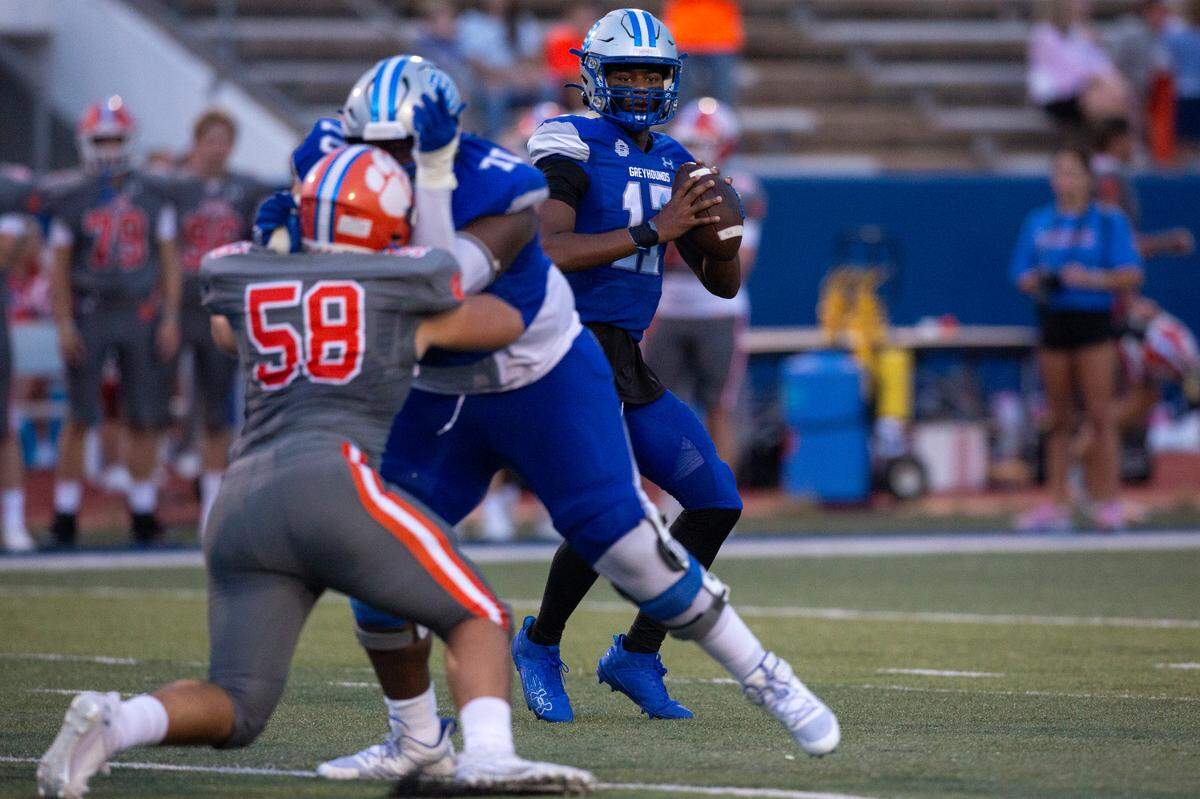 Ocean Springs’ quarterback Connor White looks to throw a pass during a game against Madison Central at Greyhound Stadium in Ocean Springs on Friday, Aug. 30, 2024.