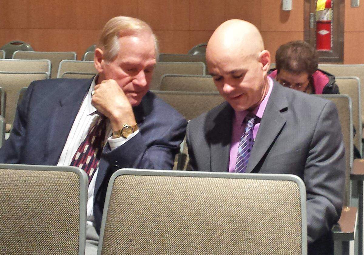 Singing River Hospital Systems CFO Lee Bond, right, and former SRHS Board of Trustees member Morris Strickland wait to meet with the Jackson County Board of Supervisors in November 2014.
