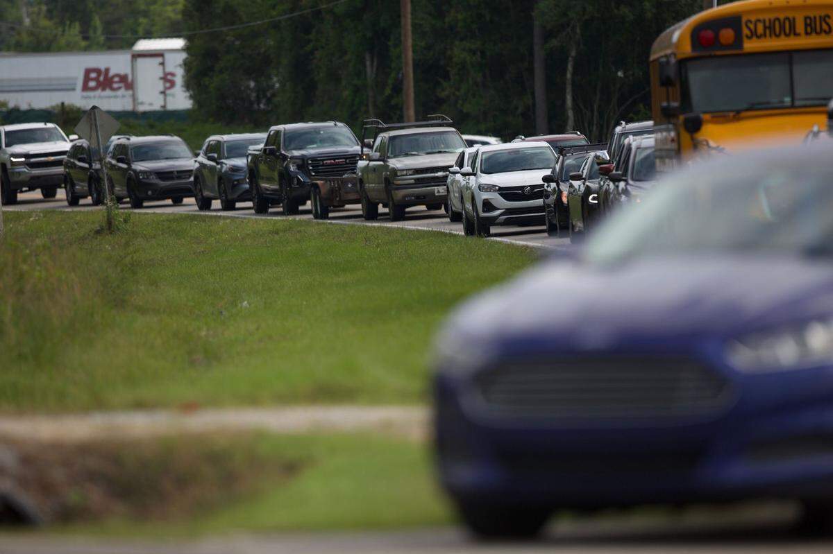 Traffic on County Farm Road was backed up Thursday as West Harrison High School and Middle School were locked down and emergency responders and parents tried to get to the schools.