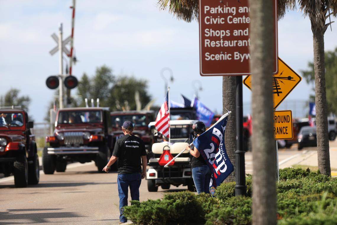 Spectators wearing “Make America Great Again” clothing and waving flags watched as hundreds of people participated in a Jeep parade supporting President Donald Trump in Bay St. Louis, Mississippi, on Saturday, Sept. 12, 2020.