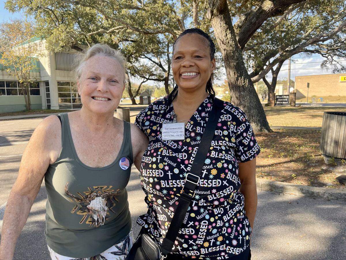 Sherry Tyson, left, and Patricia Jefferson, right, are outside the West Biloxi Library, where Tyson voted Tuesday afternoon. Jefferson, her caretaker, lives in Gulfport and plans to vote there after work.
