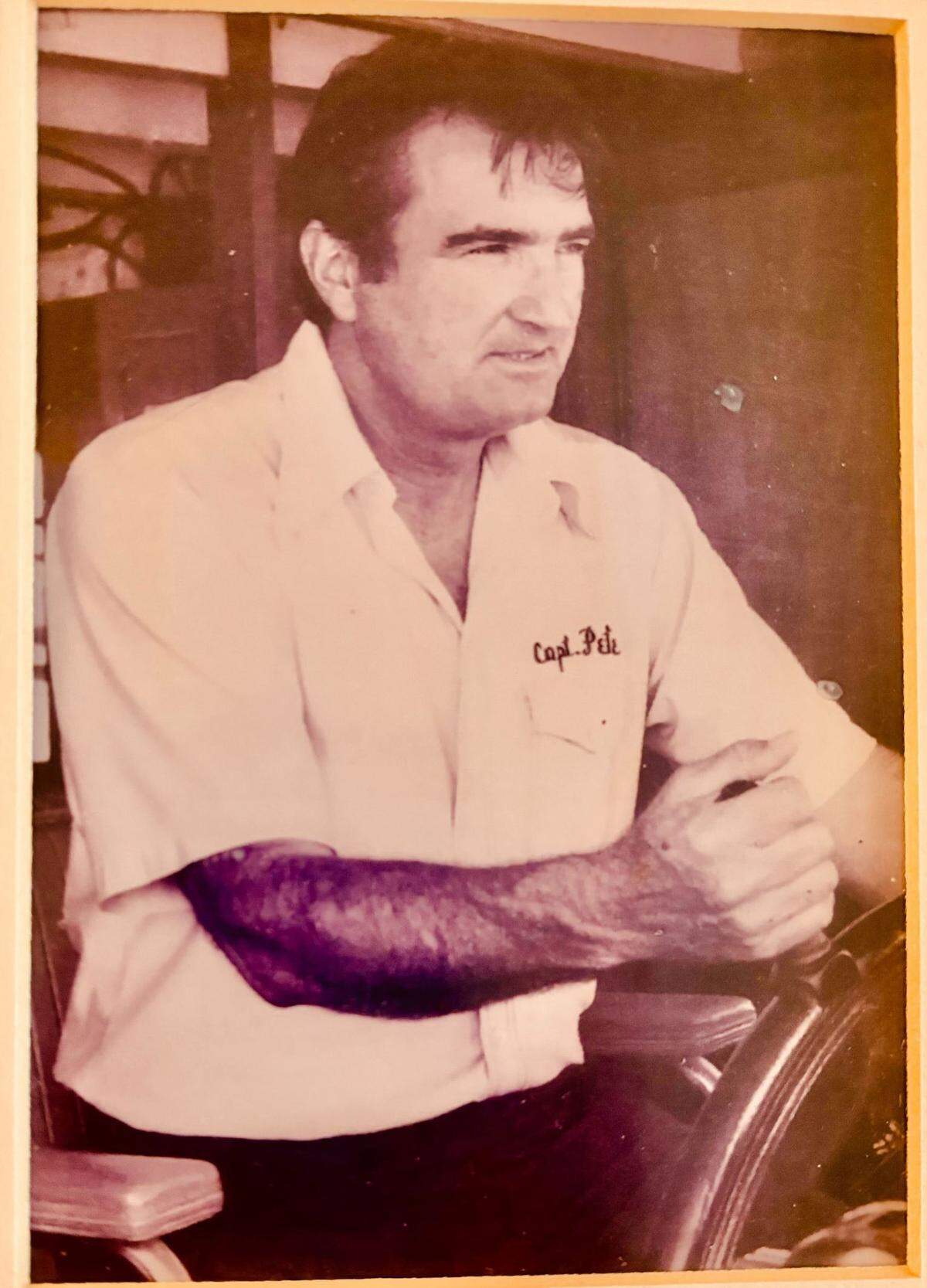 Captain Peter Skrmetta takes the helm of a ship.