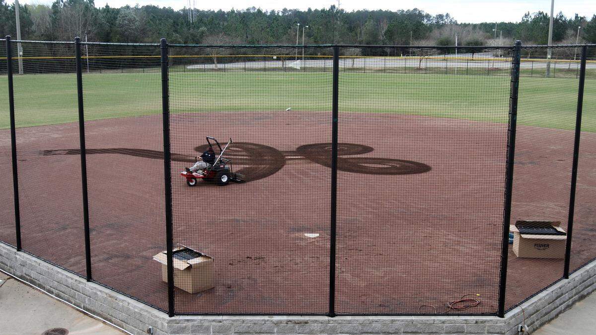 JOHN FITZHUGH/SUN HERALD 
 Doug Albritton grooms the infield dirt on one of the softball fields at the Gulfport Sportsplex on Wednesday Feb. 24, 2015 in preparation for the Mississippi Gulf Coast Softball Classic. The Softball Classic starts Friday and ends Sunday.