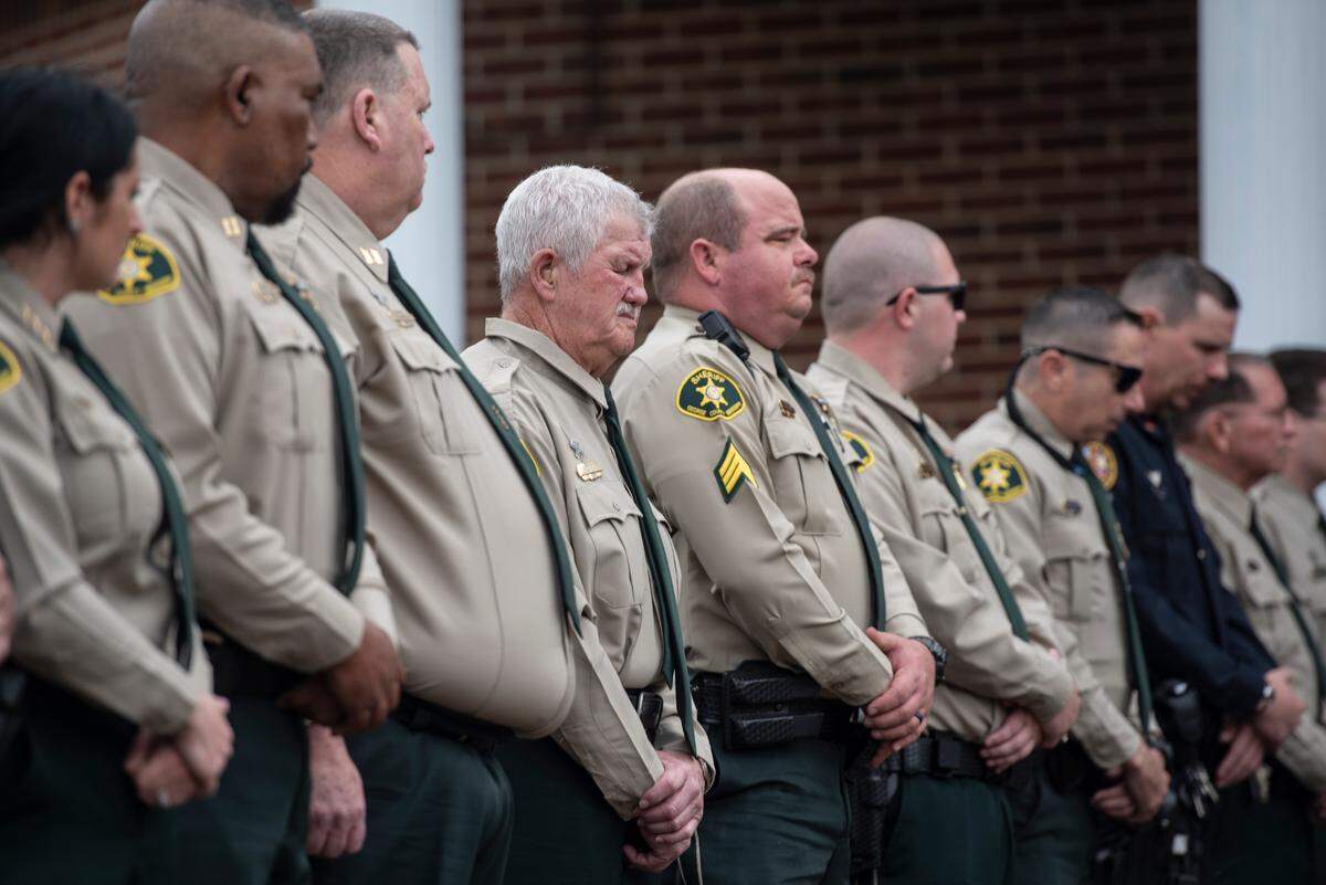 Members of the George County Sheriff’s Department stand by as of law enforcement officers carry the casket of George County Sheriff’s Deputy Jeremy Malone to the hearse following Malone’s funeral at Agricola Baptist Church in George County on Friday, Jan. 12, 2024.