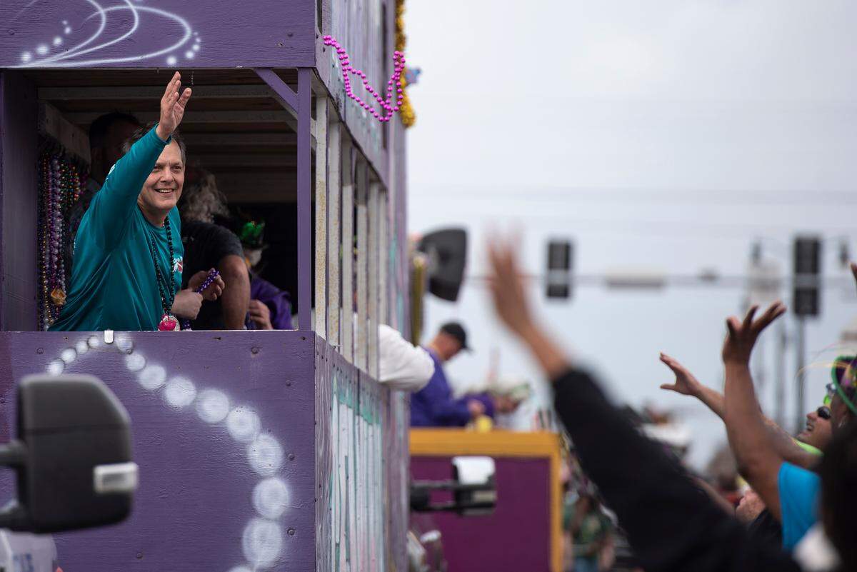 A float rider throws beads from a float during the Krewe of Gemini parade in downtown Gulfport on Saturday, Feb. 10, 2024.
