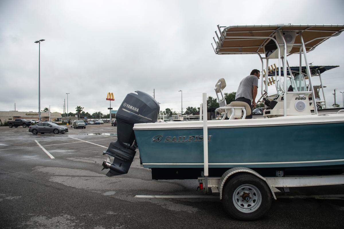 Doug Abbott, who lives on a bayou slip, parks his boat at the Auto Zone parking lot in Waveland on Tuesday, ahead of Hurricane Francine.