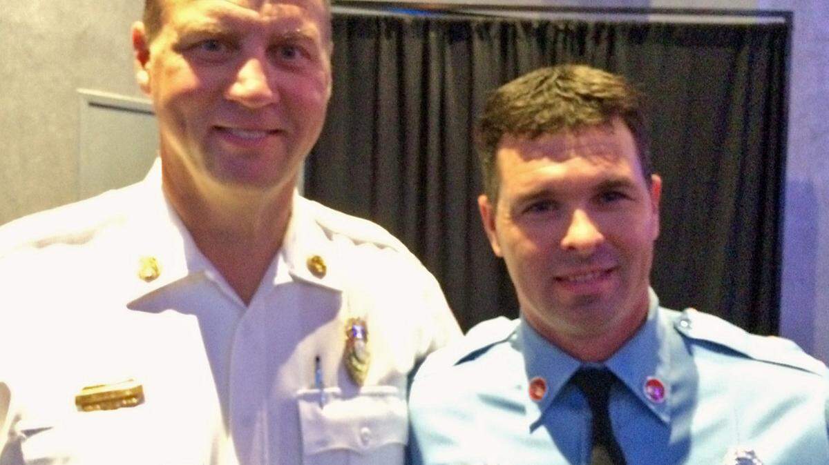 ANITA LEE/SUN HERALD 
 Gulfport fire Chief Mike Beyerstedt stands with fire Engineer Nathan Powell, named the department's officer of the year for his volunteer work and donation of materials for building projects.