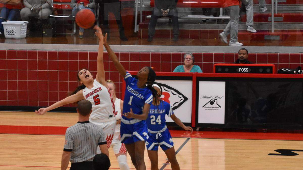Hancock forward Madelyn Ladner jumps for the ball during the opening tip off.