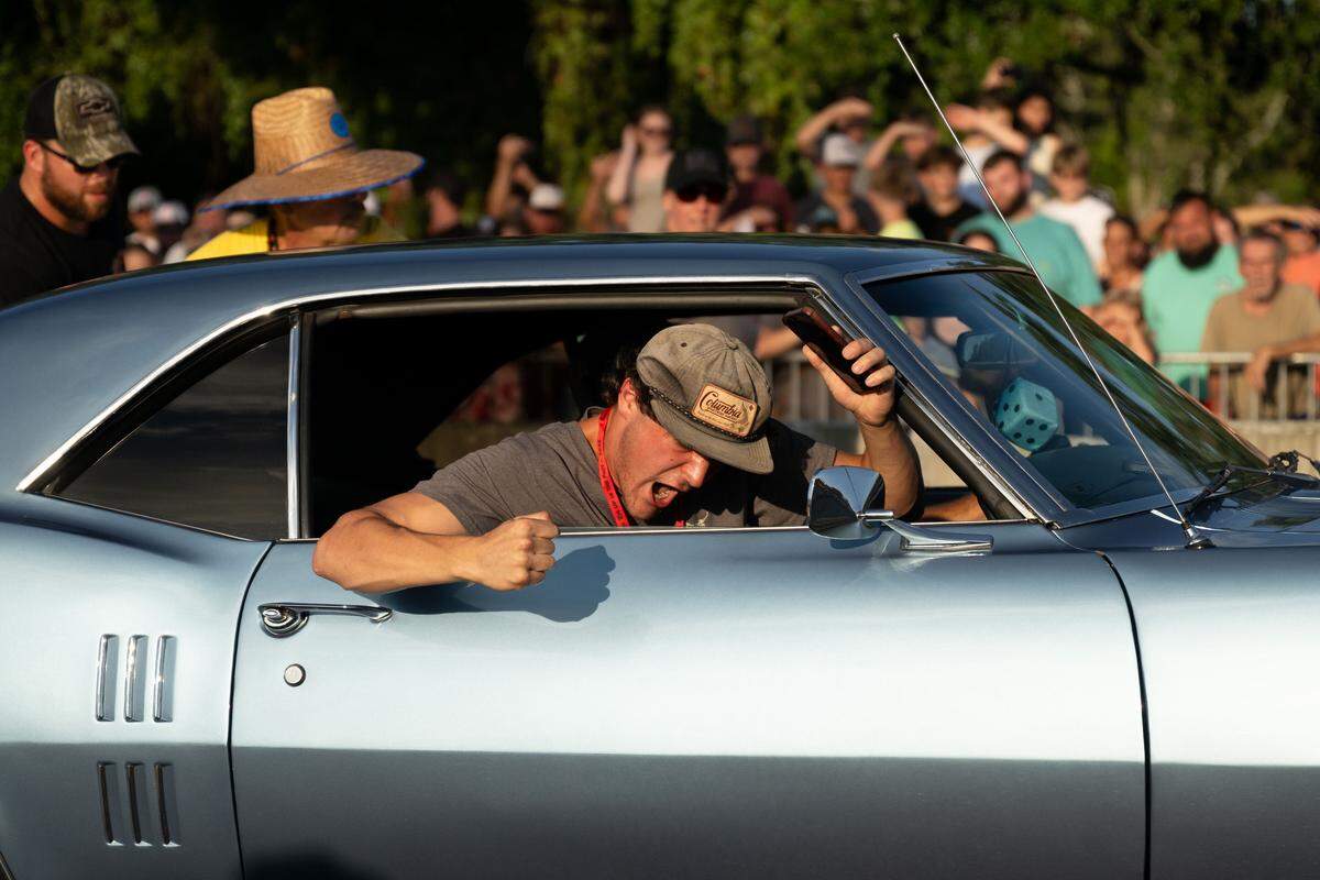 A passenger cheers as his car drives through during Burn ‘Em Up In The Pass on Thursday, Oct. 9, 2025.