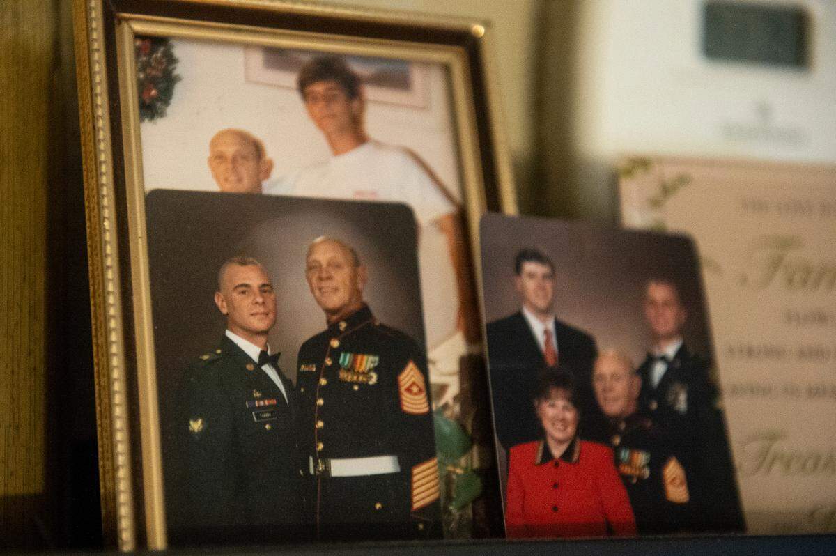 Photos of Patrick Tainsh and David Tainsh sit on a shelf in Deborah’s home in Biloxi on Wednesday, Nov. 8, 2023.