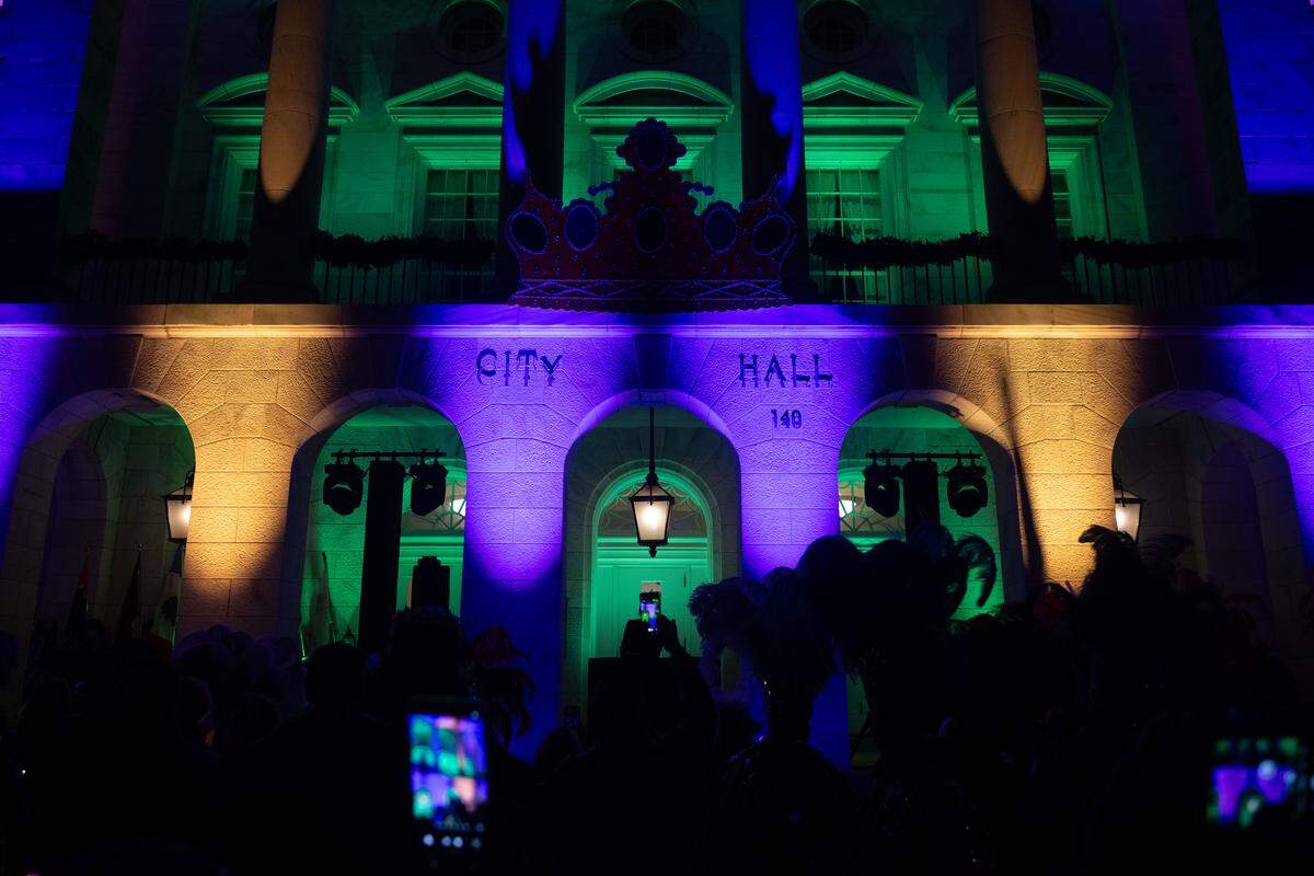The lights of City Hall change from Christmas colors to Mardi Gras colors during a 12th Night Celebration in Biloxi on Monday, Jan. 5, 2026.