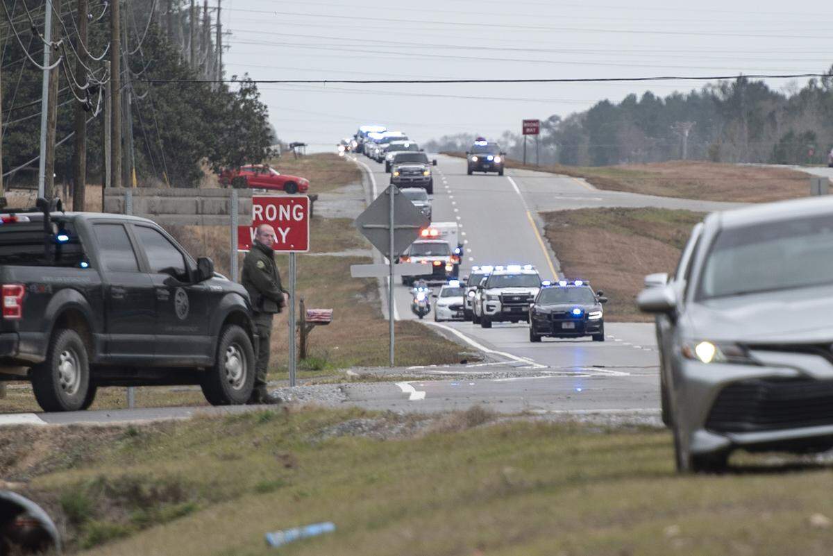 A procession escorting George County Sheriff’s officer Jeremy Malone, who was killed on Thursday, arrives at Moments Funeral Home in Lucedale on Friday, Jan. 5, 2024.