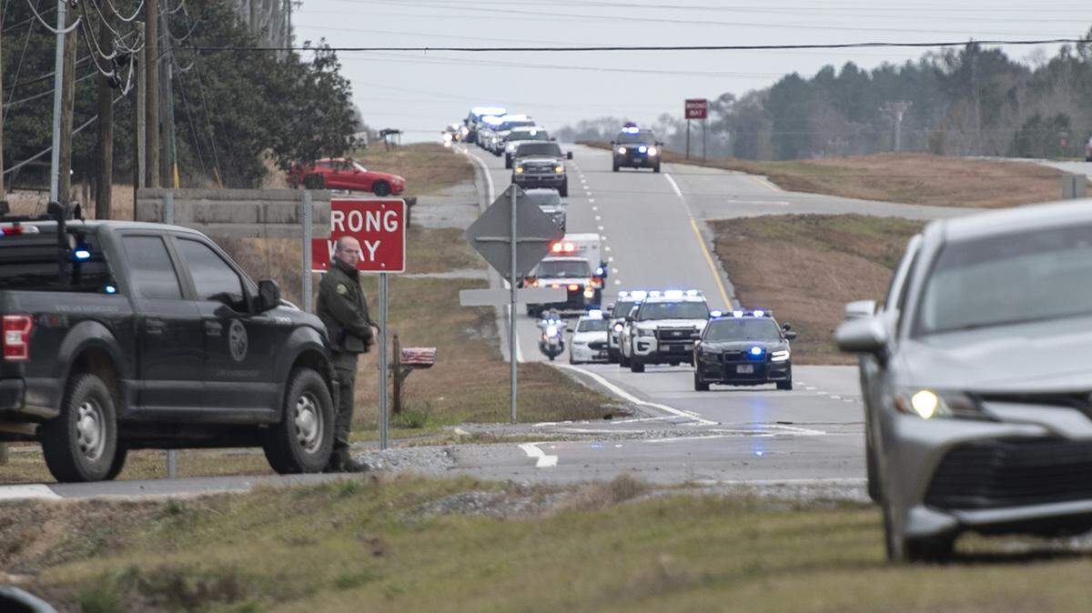 A procession escorting George County Sheriff’s officer Jeremy Malone, who was killed on Thursday, arrives at Moments Funeral Home in Lucedale on Jan. 5.