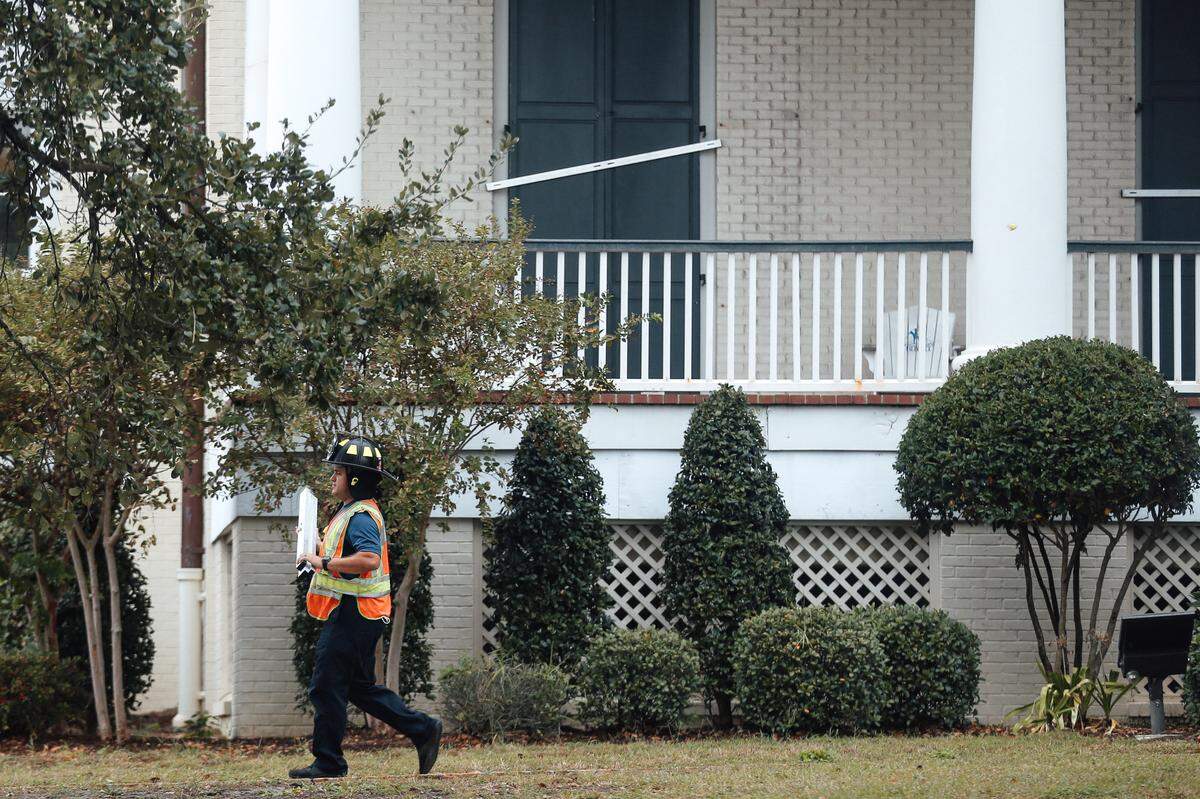 A firefighter carries a metal brace after helping shutter windows at the Biloxi Visitor Center across U.S. 90 from the Mississippi Sound. Hurricane Zeta is expected to bring high winds, rain and storm surge to the Mississippi Coast.