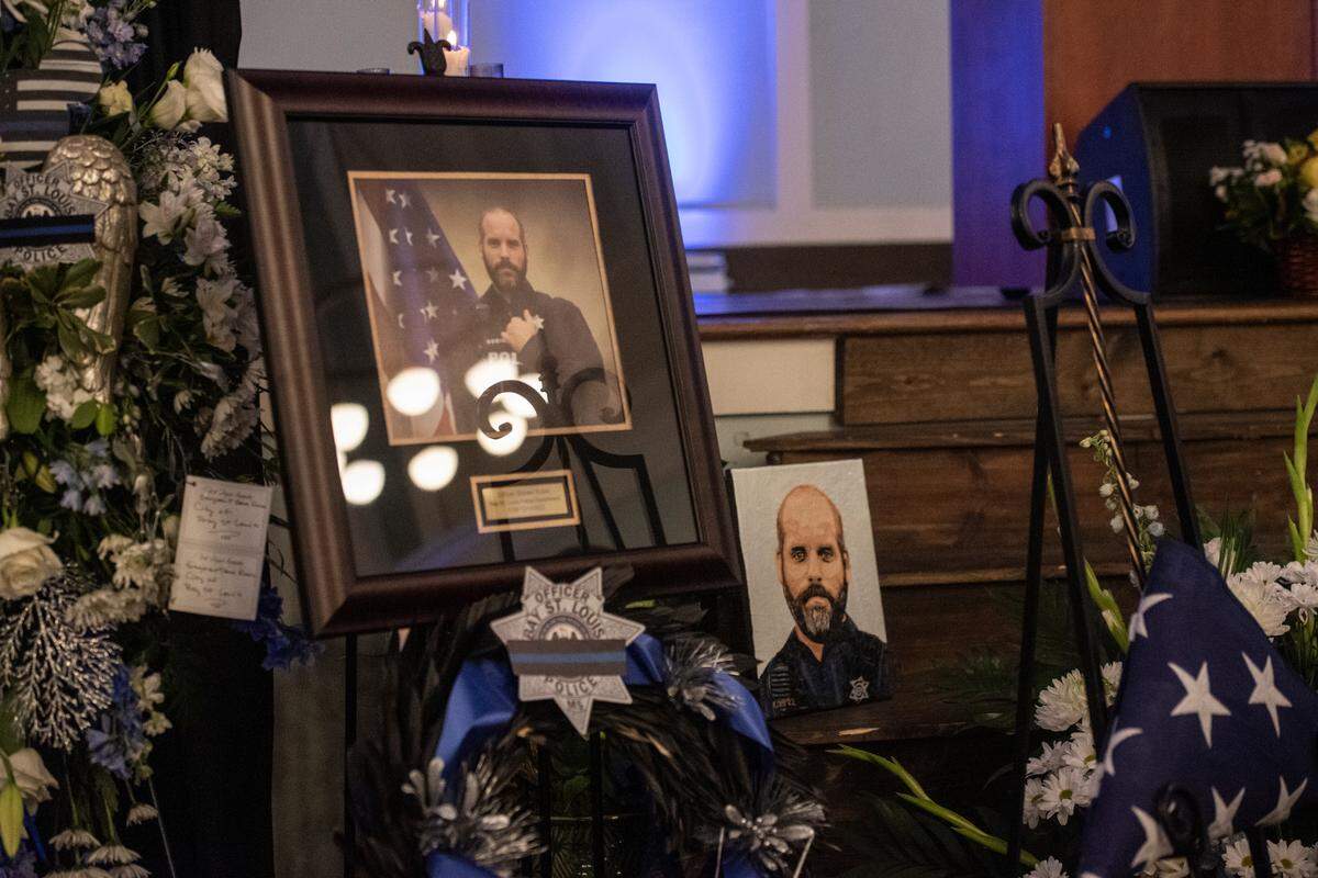Steven Robin’s portrait looks out on the crowd during the funeral of Bay St. Louis police officers Sgt. Steven Robin and Branden Estorffe at the Bay St. Louis Community Center in Bay St. Louis on Wednesday, Dec. 21, 2022. Robin and Estorffe were killed responding to a call at a Motel 6 on Dec. 14.