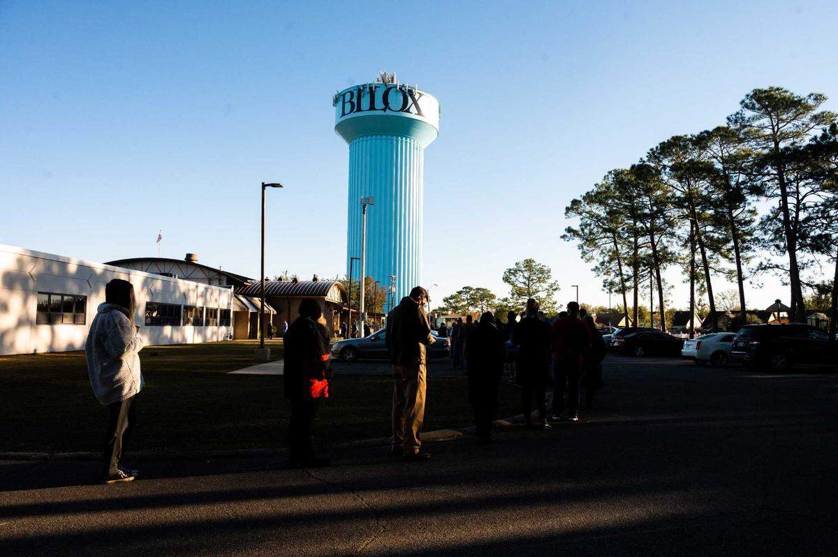 Voters wait in line outside the Sherry Library in Biloxi on Election Day, Tuesday, Nov. 3, 2020.