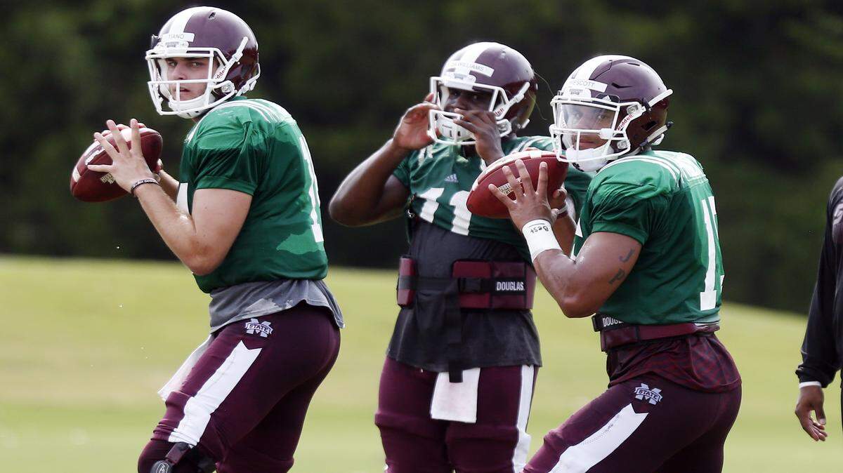ROGELIO V. SOLIS/ASSOCIATED PRESS 
 Mississippi State quarterbacks Nick Fitzgerald, left, and Damian Williams, middle, are duking it out with Elijah Staley and Nick Tiano to replace Dak Prescott, right, as the Bulldogs' starter.