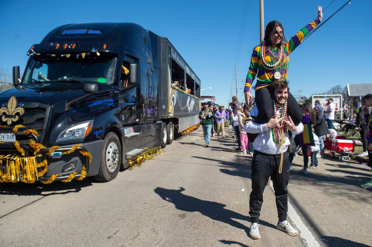 Revelers take photos with floats during the Krewe of Nereids Mardi Gras parade on Highway 90 in Bay St. Louis on Sunday, Feb. 12, 2023.