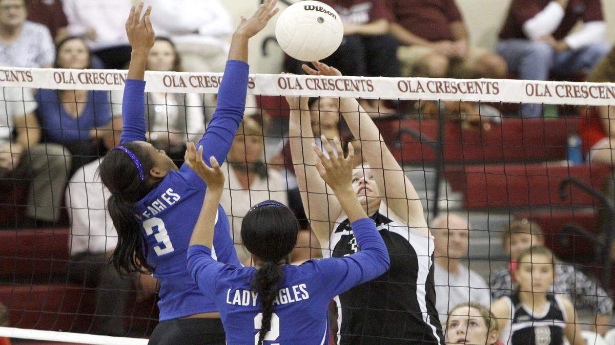 TIM ISBELL/SUN HERALD 
 Daja Cowan and Jada Williams of Resurrection attempt to block the shot of OLA's Hannah Gest, Tuesday, Oct. 27, 2015.
