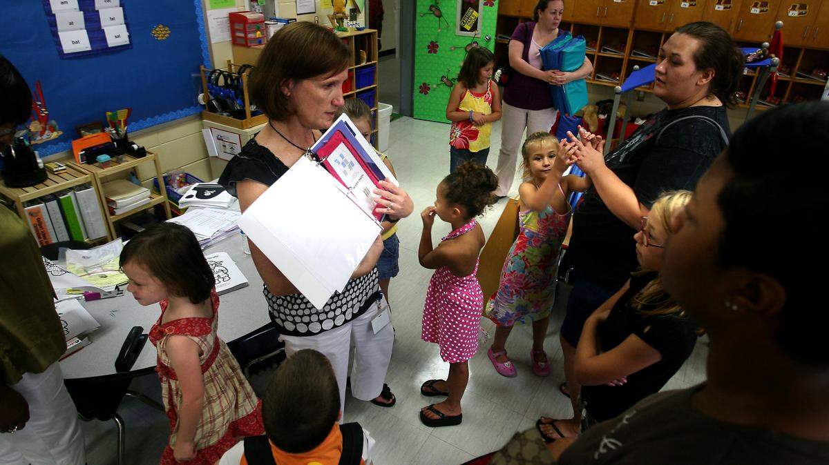 AMANDA McCOY/SUN HERALD/FILEParents and children gather around while Pamela Phillips, center, explains some of the ins-and-outs of her kindergarten class in 2009.