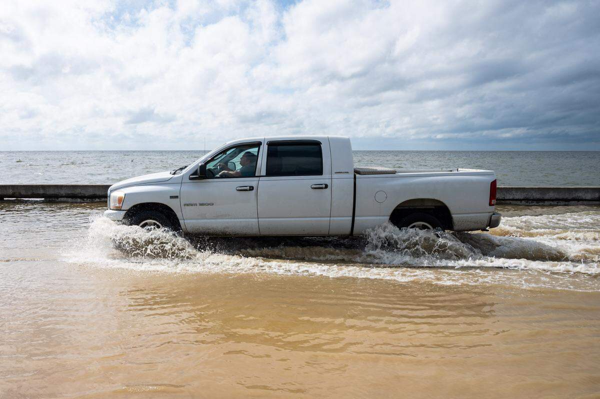 A truck plows through water as Beach Boulevard floods in Waveland on Monday, Sept. 14, 2020.