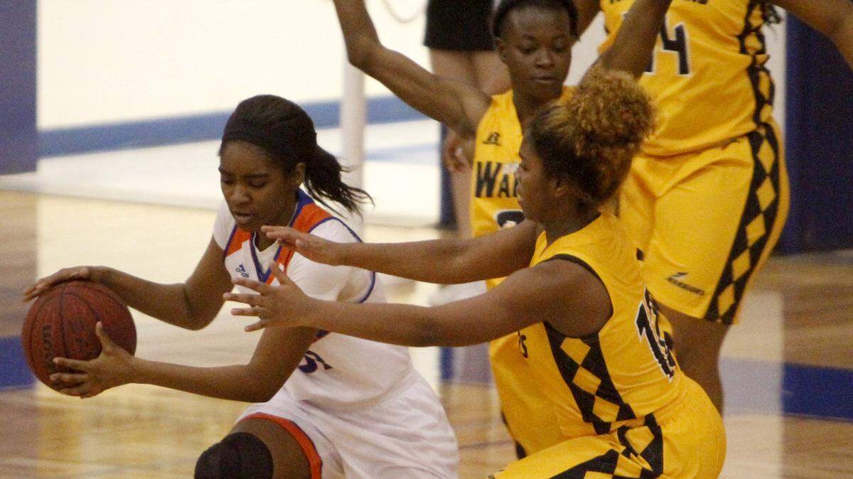 TIM ISBELL/SUN HERALDGulfport's Nishiana Heard is hounded by D'Iberville guard Mylia Quinn, Monday, Feb. 22, 2016. 